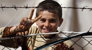 Syrian refugee flashes a victory sign at Reyhanli refugee camp in Hatay province