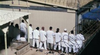 Detainees participate in an early morning prayer session at Camp IV at the detention facility in Guantanamo Bay U.S. Naval Base