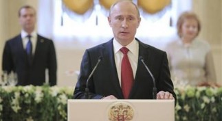 Russia's new President Vladimir Putin (front), speaks during a reception dedicated to the start of his term as Russia's new President at the Kremlin in Moscow