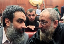 Salafist cleric leader Borhamy speaks with al-Zarqa, one of the advisors to Egypt's President Mursi, at the Shura Council during the final vote on a draft new Egyptian constitution in Cairo