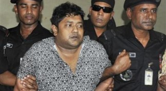 Members of the Rapid Action Battalion present Mohammed Sohel Rana to the media after his arrest, in Dhaka