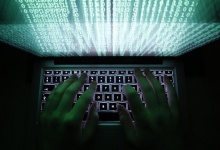 Illustration file picture shows a man typing on a computer keyboard in Warsaw