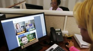 Janet Perez oversees specialists help callers with health insurance, at a customer care center in Providence, Rhode Island