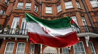 A voter holds a flag outside the Iranian consulate in central London