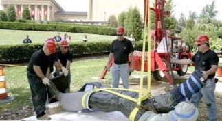 Workers prepare to lift the "Rocky" statue to place it near the Philadelphia Museum of Art in Philadelphia
